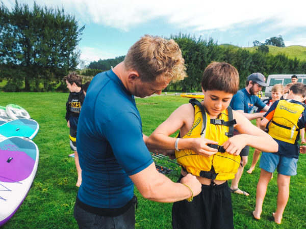 Waimarino Adventure Park | Instructor Helping Child with PFD