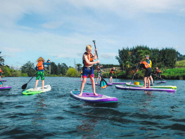 Waimarino Adventure Park | Group of Children Stand Up Paddle Boarding